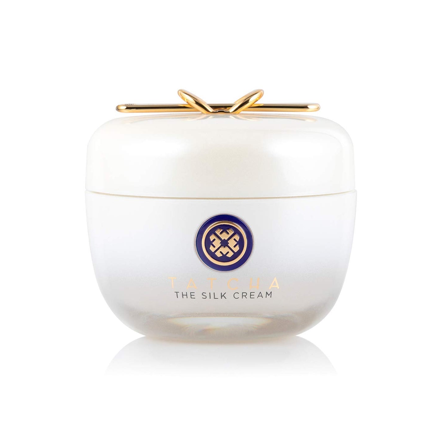 White jar of 'The Silk Cream' with a gold lid on a white background