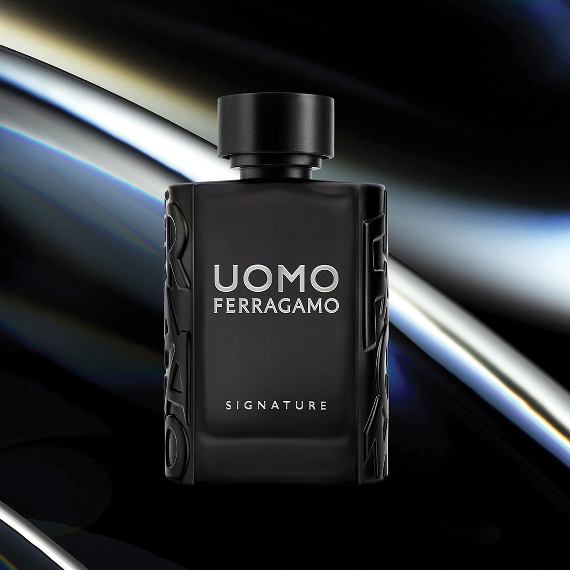Black perfume bottle labeled 'Uomo Ferragamo Signature' on a dark background