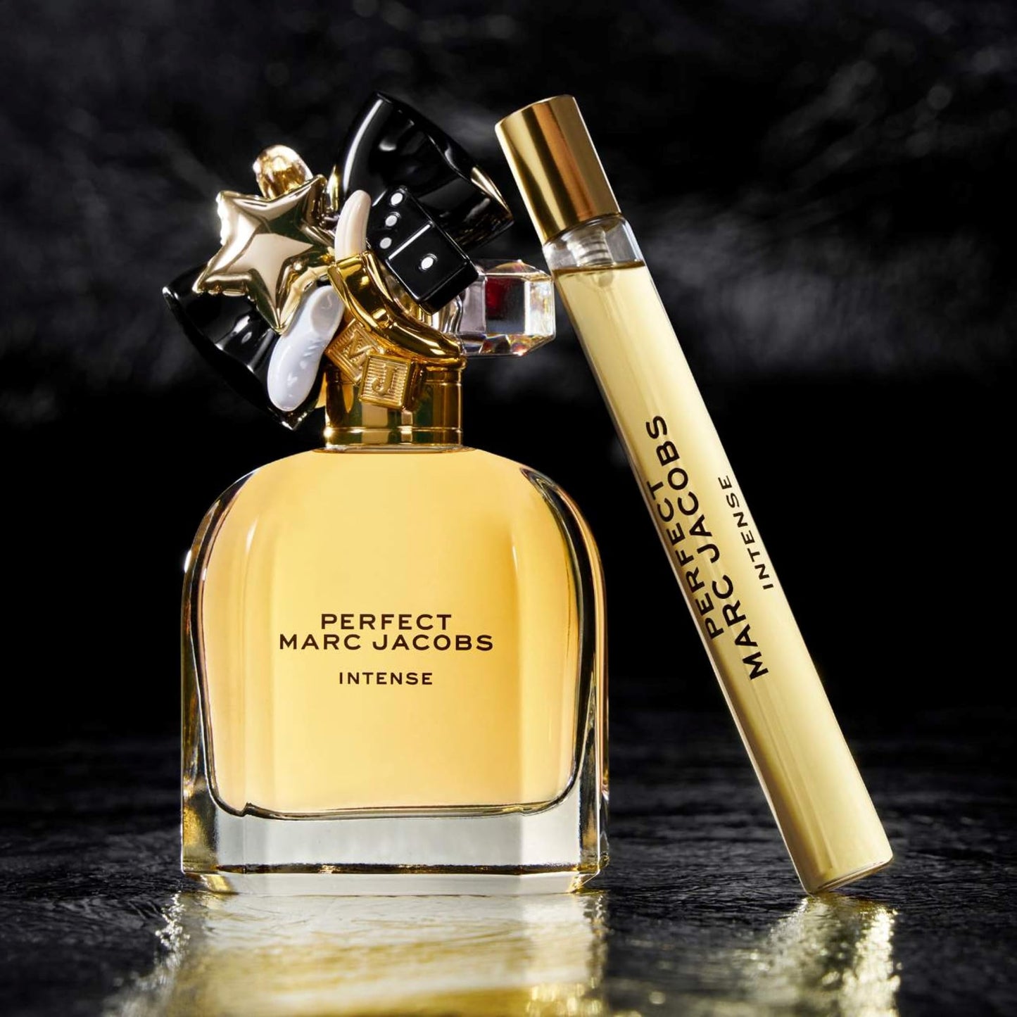 Marc Jacobs perfume bottle and rollerball on a dark background