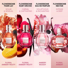 Four Flowerbomb perfume bottles with floral designs and product names on a pink background.